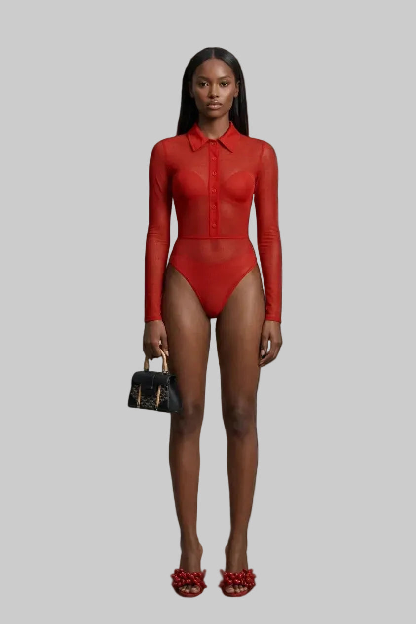 Studio editorial shot highlighting the high cut sculpted silhouette of the sheer carnelian mesh bodysuit paired with the matching with the matching collared button front top.