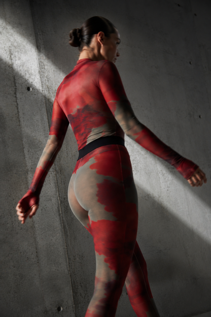 Rear view of a model wearing the Superior Agate Secondskin Burgundy MYCA Set, showcasing the sleek fit of the semi-sheer mesh top and high-waisted footed stocking leggings.