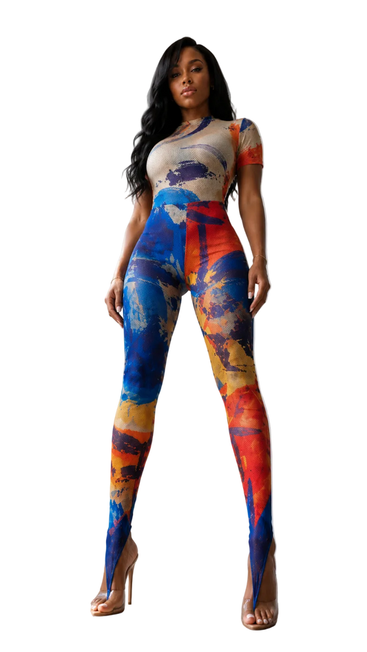 Full-length low angle perspective view of a model wearing The MYCA Canvas Body Series abstract print bodycon jumpsuit, featuring a short-sleeve top and stirrup leggings in a blue, orange, and red paint stroke pattern on a transparent background
